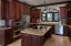Spacious gourmet kitchen with custom mahogany cabinets